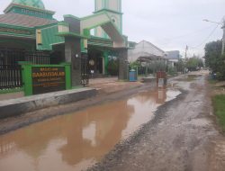 Jalan berlubang tergenang air di depan Masjid Babbusalam Perumahan Wahana Harapan Kelurahan Setia Asih Kec. Tarumajaya